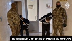 In this photo taken from video released by Investigative Committee of Russia on March 24, 2024, suspects in the Crocus City Hall shooting on Friday are escorted inside the Russian Investigative Committee headquarters in Moscow, Russia. 