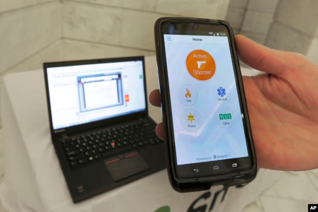 FILE - A smartphone is held during a demonstration of the Rave Panic Button application at the Arkansas state Capitol in Little Rock, Ark., Aug. 11, 2015. (AP Photo/Danny Johnston, File)