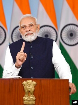 Indian Prime Minister Narendra Modi addresses G-20 atendees in Bangaluru, through a video message from New Delhi, India, Feb. 24, 2023. (Indian Press Information Bureau via AP)