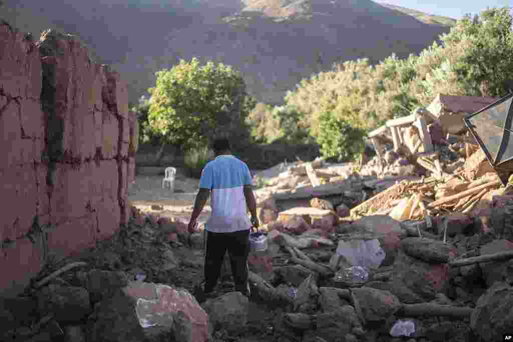 Mohammed Elhmatif walks amidst the rubble of his home which was damaged by the earthquake, in Ijjoukak village, near Marrakech, Morocco, Sept. 9, 2023.