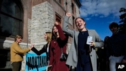 FILE - Youth plaintiffs in the climate change lawsuit, Held vs. Montana, arrive at the Lewis and Clark County Courthouse, June 20, 2023, in Helena, Montana, for the final day of the trial. 