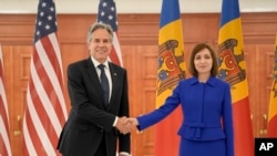 U.S. Secretary of State Antony Blinken. left, shakes hands with Moldova's President Maia Sandu, right, at the Presidential Palace in Chisinau, Moldova, May 29, 2024. 