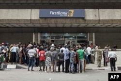 FILE - People queue outside a bank in Lagos, Nigeria, Feb. 22, 2023.