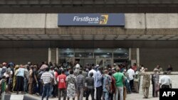ARCHIVES - Des clients en quête de liquidité font la queue devant une banque à Lagos, au Nigeria, le 22 février 2023.