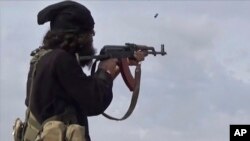 FILE - This frame from video posted online March 18, 2019, by the Aamaq News Agency, a media arm of Islamic State, shows an IS fighter during clashes in Baghouz, Syria. IS gunmen ambushed a bus carrying Syrian soldiers on Aug. 10, 2023, killing at least 20 and wounding others.