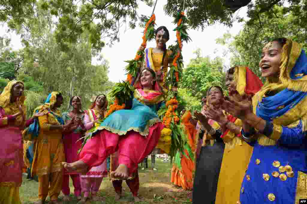 College students wearing traditional Punjabi attire celebrate the Teej festival in Amritsar, India.