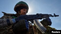 A Ukrainian service member is seen in a trench at a position on a front line, as Russia's attack on Ukraine continues, near the city of Bakhmut, Ukraine April 10, 2023.