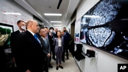 Russian Prime Minister Mikhail Mishustin, left, visits the Tsinghua University, in Beijing, China, Wednesday, May 24, 2023. (Government Pool Photo)