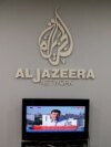 FILE - The logo of Qatar-based Al-Jazeera network is seen in one of their offices in Jerusalem, June 13, 2017. 