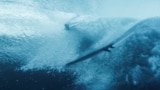 A surfer takes part in training session in Teahupo'o, on the French Polynesian Island of Tahiti, July 22, 2024, ahead of the Paris 2024 Olympic Games. 