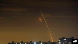 Russian rockets launching against Ukraine from Russia's Belgorod region are seen at dawn in Kharkiv, Ukraine, May 14, 2023. 