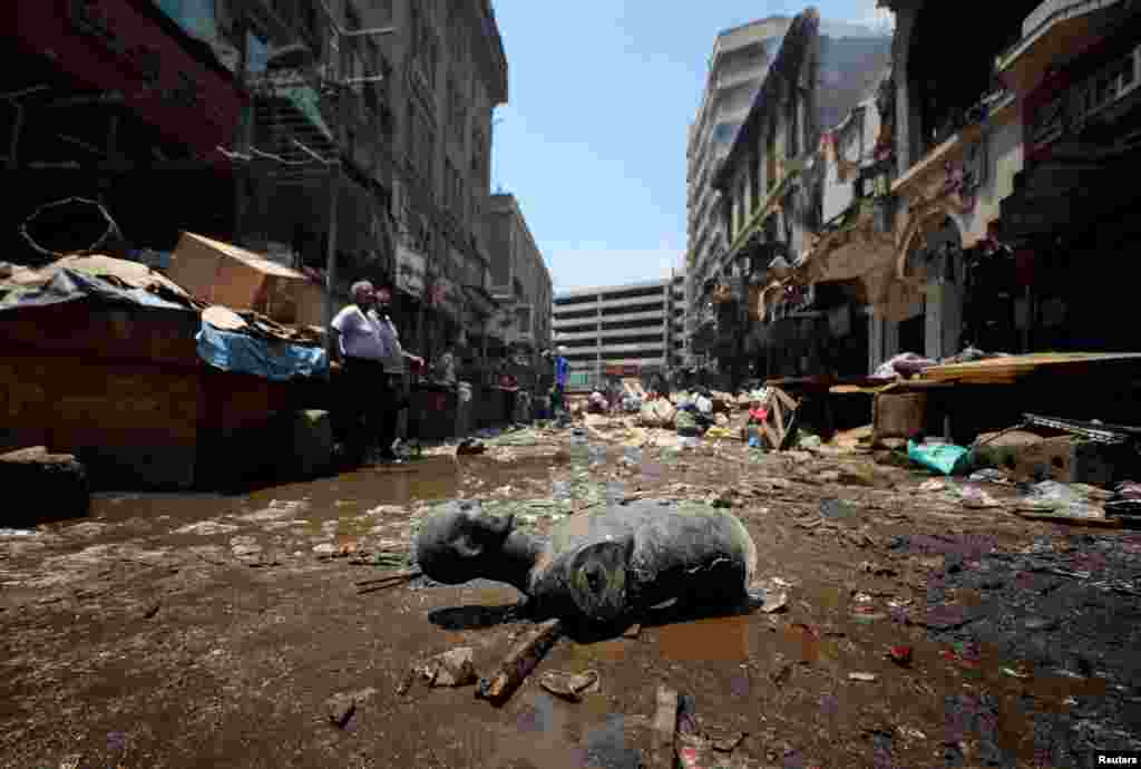 A mannequin part lies near damaged shops in a popular commercial hub area after a major fire in the downtown neighborhood of Ataba in Cairo, Egypt.