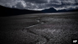 FILE - A usually submerged section of the lake Serre-Poncon is dry in southern France, March 14, 2023.