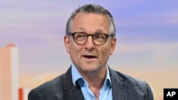 In this undated photo provided by the BBC on June 9, 2024, doctor and broadcaster Michael Mosley speaks on Sunday with Laura Kuenssberg. 