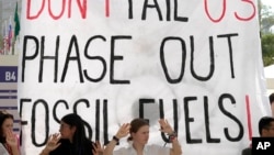 Activists demonstrate with a sign that reads "Don't fail us phase out fossil fuels" at the COP28 U.N. Climate Summit, Dec. 12, 2023, in Dubai, United Arab Emirates. 