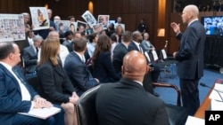 During a U.S. Senate hearing in Washington on June 18, 2024, Boeing CEO Dave Calhoun apologizes to relatives of victims of Boeing 737 Max crashes in 2018 and 2019. Some of those at the hearing held up photos of loved ones who died in the two crashes, which killed a total of 346.