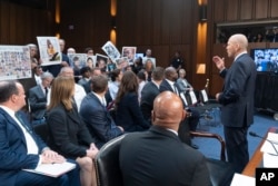 FILE - Boeing Company President and CEO Dave Calhoun apologizes to families of victims during the Senate Homeland Security and Governmental Affairs Subcommittee on Investigations hearing to examine Boeing's safety culture in Washington, June 18, 2024.