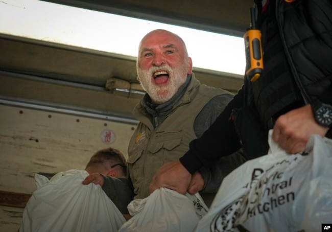 FILE - Jose Andres, a Spanish chef, and founder of World Central Kitchen unloads the humanitarian food packages delivered with WCK's truck in Kherson, Ukraine, on Nov. 15, 2022. (AP Photo/Efrem Lukatsky, File)