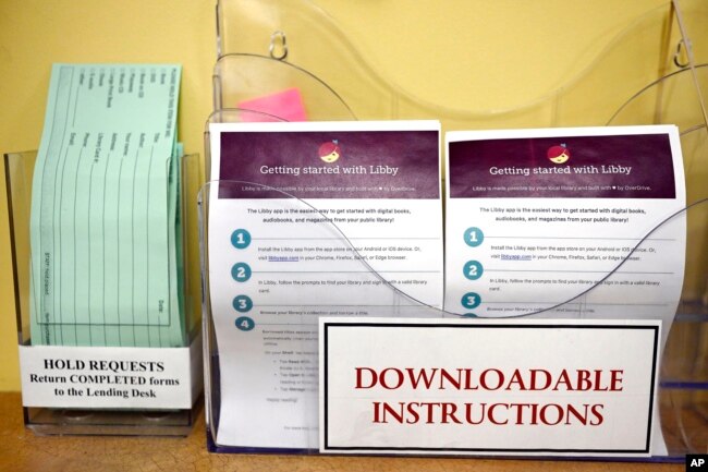 Instructions for using Libby, a free app for e-books, digital audiobooks and magazines is on display at the Windsor Public Library in Windsor, Conn., Feb. 1, 2024. (AP Photo/Jessica Hill)