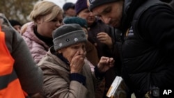 A woman reacts after receiving food aid from World Central Kitchen in Kherson, Ukraine, Nov. 17, 2022. The image was part of a series of images by Associated Press photographers that was a finalist for the 2023 Pulitzer Prize for Feature Photography. The AP got the nod for Breaking News Photography.