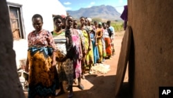 FILE - Pregnant women queue to see Lucy Mbewe, a traditional birth attendant, at her home in Simika Village, Chiradzulu, southern Malawi, May 23, 2021. Health officials say fewer women are getting prenatal care amid the COVID-19 pandemic. 