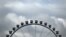 FILE - Clouds hang over a Ferris wheel during the Oktoberfest beer festival in Munich, southern Germany, Sept. 17, 2022. A Ferris wheel caught fire Saturday night at a music festival near Leipzig in eastern Germany, injuring at least 23 people, 