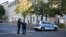 FILE - German police officers stand guard in front of the building complex of the Kahal Adass Jisroel community, which houses a synagogue, a kindergarten and a community center, in the center of Berlin, Germany, Oct. 18, 2023.