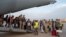 French and other nationalities disembark at a French military air base in Djibouti, April 23, during their evacuation from Sudan on the first French flight out of the war-hit country.