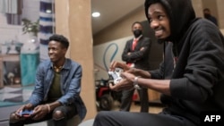 FILE - Contestants participate in a gaming session at an exhibition of gaming electronics in Nairobi, Kenya, on Oct. 22, 2021.