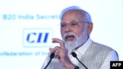India's Prime Minister Narendra Modi addresses the gathering on the third day of the three-day B20 Summit in New Delhi on Aug. 27, 2023. 