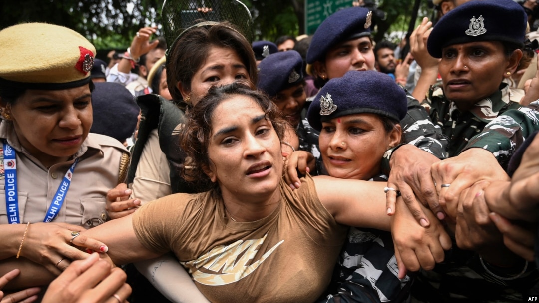 Indian wrestler Vinesh Phogat (C) is detained by the police during a protest against Brij Bhushan Singh, the wrestling federation chief, in New Delhi on May 28, 2023.