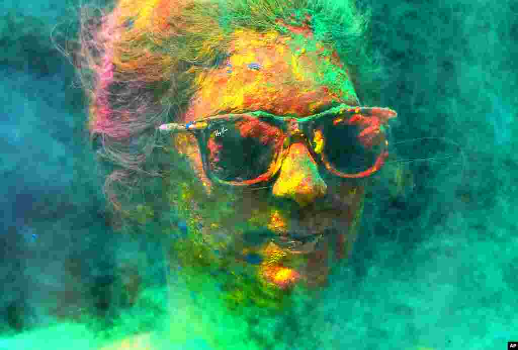 A woman covered with colors celebrates Holi, the Hindu festival of colors, in Mumbai, India.