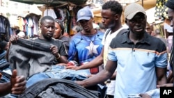 Ugandans buy secondhand clothes at Owino Market in Kampala, Uganda, Sept. 15, 2023. 