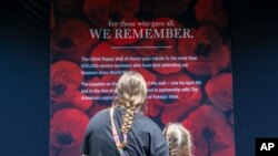 Visitors are seen at the USAA Poppy Wall of Honor at the National Mall in Washington, May 24, 2024. 