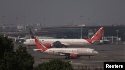 Air India passenger jets are seen on the tarmac at Chhatrapati Shivaji International airport in Mumbai, India, Feb. 14, 2023.