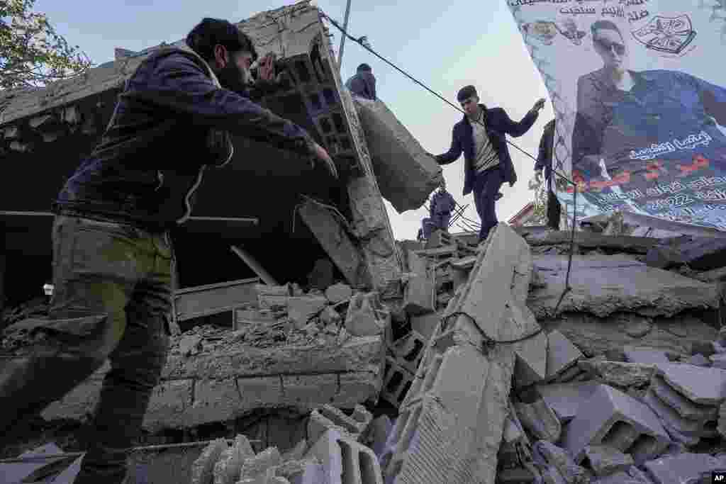 Palestinians inspect the ruins of the house of Palestinian militant, Mohammad Souf, that was destroyed by Israeli troops in the West Bank village of Haris.