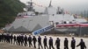 Navy soldiers walk past a Taiwan-made corvette warship during the inauguration ceremony in Yilan on March 26, 2024. 