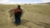 FILE - A Maasai woman walks in the Ngorongoro Conservation Area, northern Tanzania, Aug. 26, 2007. 