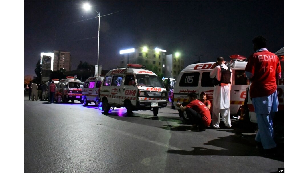 Ambulances are parked close to the incident site following an attack by gunmen on police headquarters, in Karachi, Pakistan, Feb. 17, 2023.