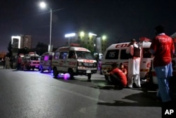 Ambulances are parked close to the incident site following an attack by gunmen on police headquarters, in Karachi, Pakistan, Feb. 17, 2023.