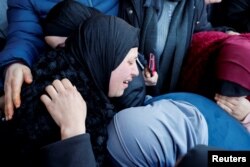 FILE - The mother and relatives of 22-year-old Palestinian Ameer Bustami, who was killed in an Israeli army raid, react during his funeral in Nablus in the Israeli-occupied West Bank, February 13, 2023.