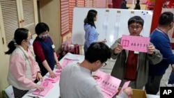 FILE - Polling officers count votes in New Taipei City, Taiwan, Jan. 13, 2024.