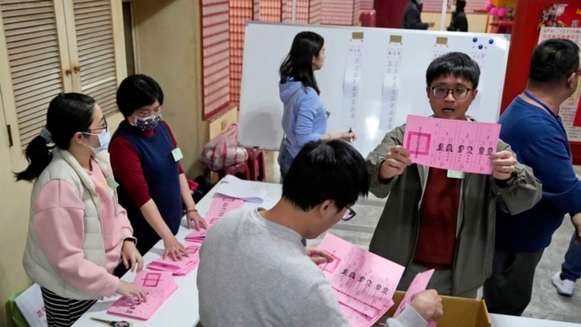 FILE - Polling officers count votes in New Taipei City, Taiwan, Jan. 13, 2024.