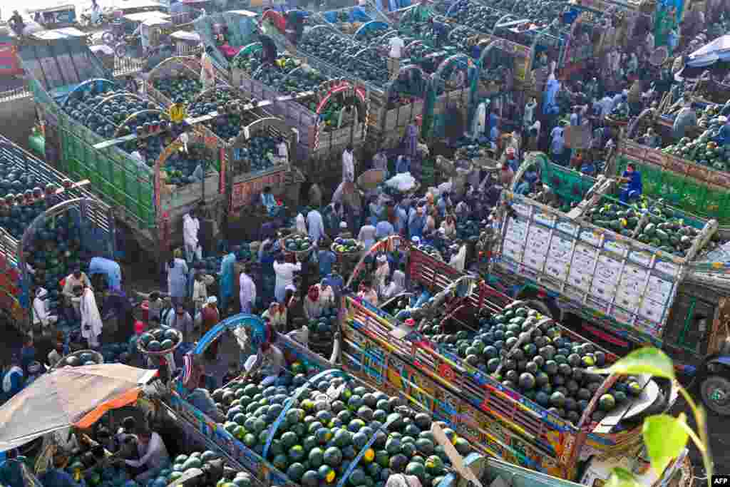 Farmers sell watermelons at the fruit market in Lahore, Pakistan.