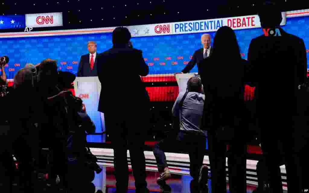 Los fotógrafos tratan de captar imágenes del presidente Joe Biden y del candidato presidencial republicano, el expresidente Donald Trump, durante una pausa en el debate presidencial organizado por CNN.
