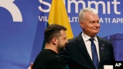FILE - Ukraine's President Volodymyr Zelenskyy, left, stands with Lithuania's President Gitanas Nauseda after addressing a media conference in Vilnius, Lithuania, on April 11, 2024. 