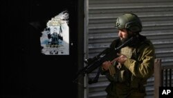 Israeli soldiers are seen in the Jenin refugee camp, West Bank, Dec. 12, 2023. The Israeli military has rounded up hundreds of Palestinians across the northern Gaza Strip as it seeks to collect intelligence about Hamas operations.