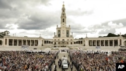FILE - Pope Francis in his popemobile leaves at the end of a Mass where he canonized shepherd children Jacinta and Francisco Marto at the Sanctuary of Our Lady of Fatima, May 13, 2017, in Fatima, Portugal. 