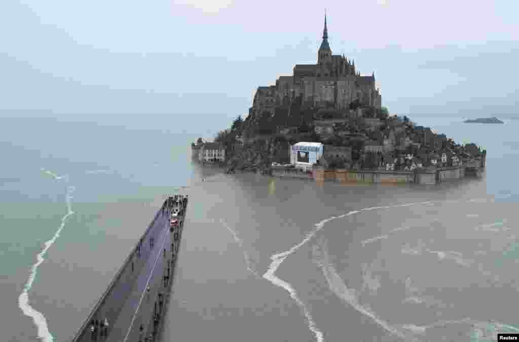 A drone view shows Mont Saint-Michel surrounded by sea during a high tide, in the French western region of Normandy.