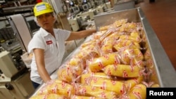 FILE -- A worker boxes up "Twinkies" snack cakes at a plant in Schiller Park, Illinois,